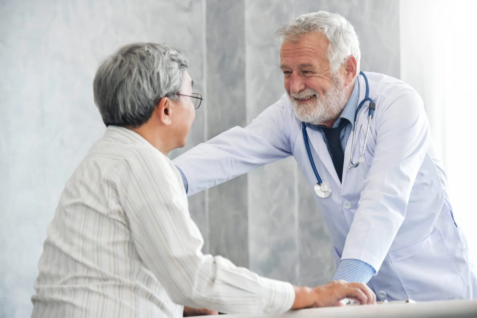 Primary care physician consulting with an older adult patient in a rural health clinic | DermaSensor