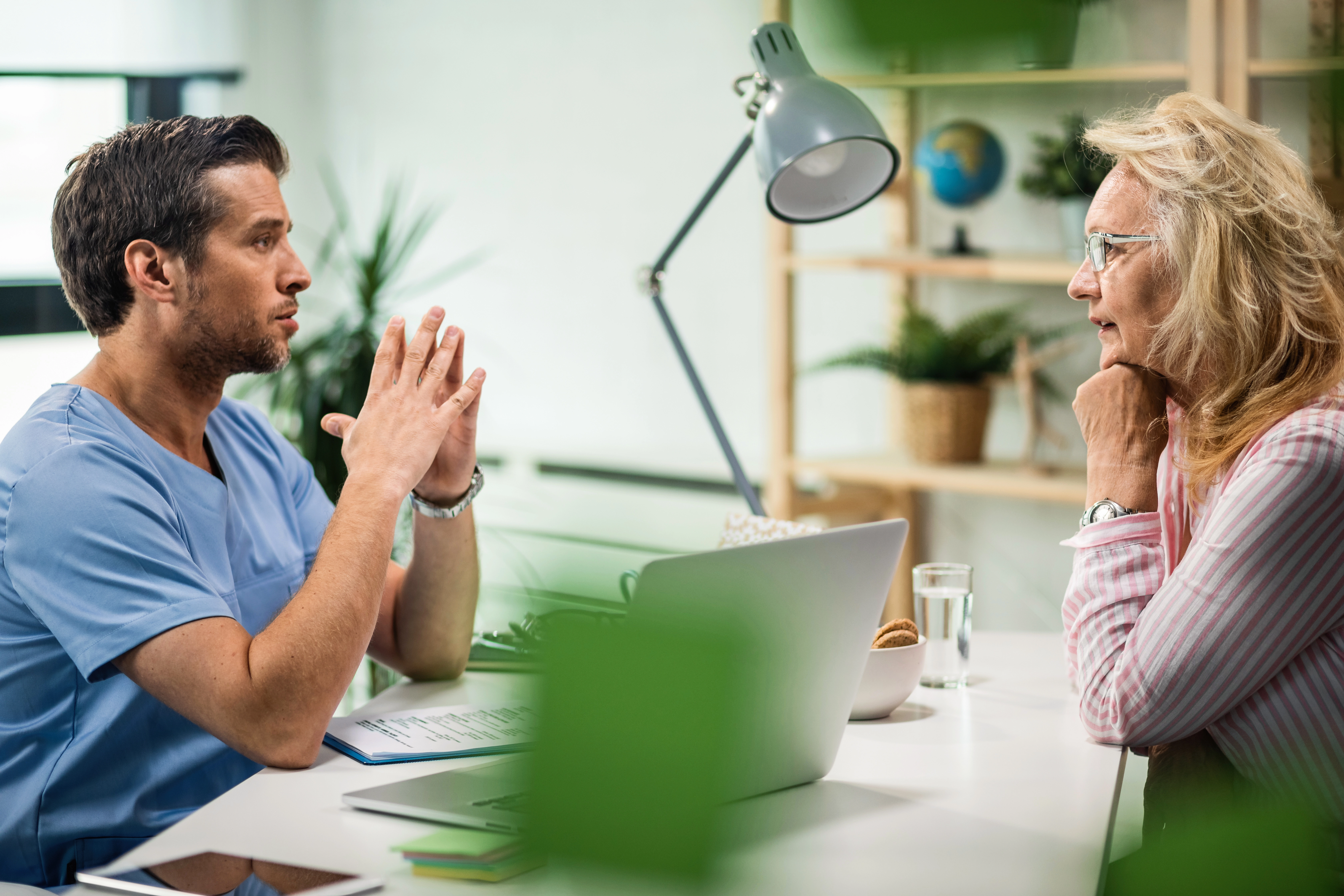 Primary care provider discussing care options with an older adult patient, in a practice using DermaSensor for skin cancer detection in rural clinics